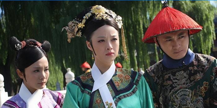 Dívky a chlap v národních čínských kostýmech