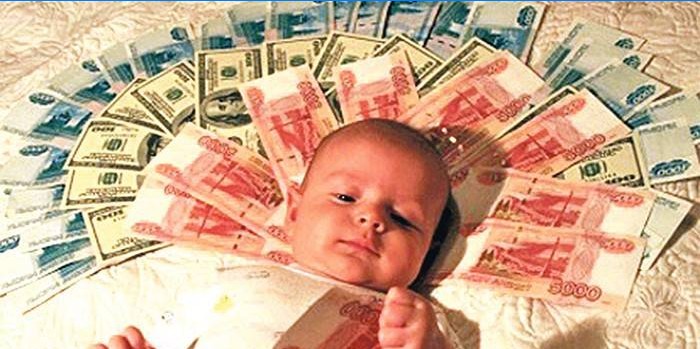 Dítě leží na bankovkách