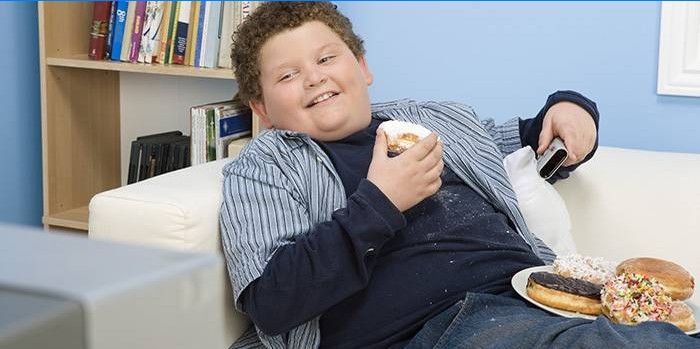 Chlapec s jídlem na gauči