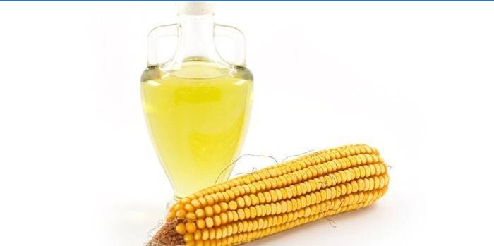 Kukuřice a kukuřičný olej ve skleněné nádobě